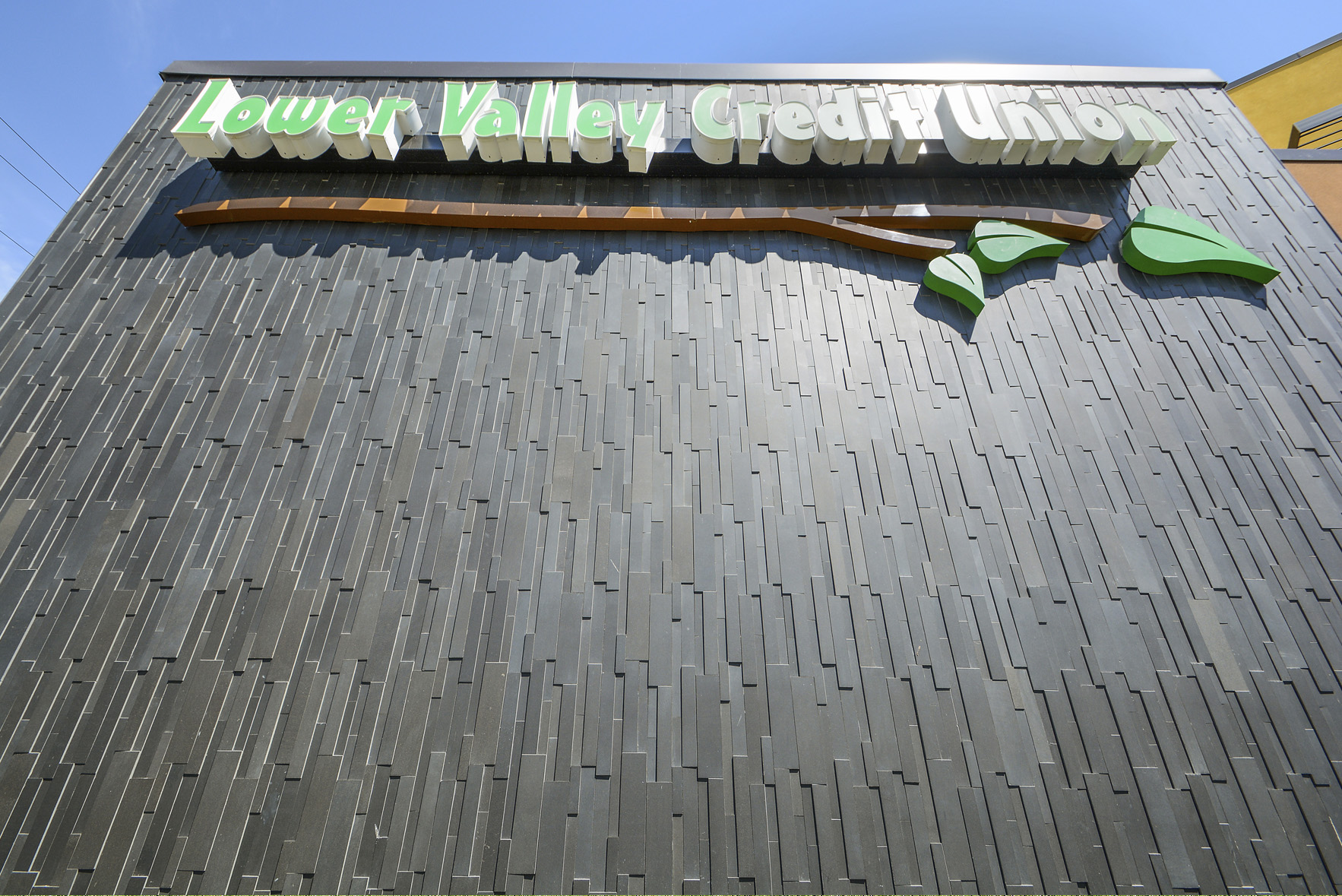 Signage at a bank in Washington state that used Norstone 3D Basalt panels in Ebony on a vertical orientation.
